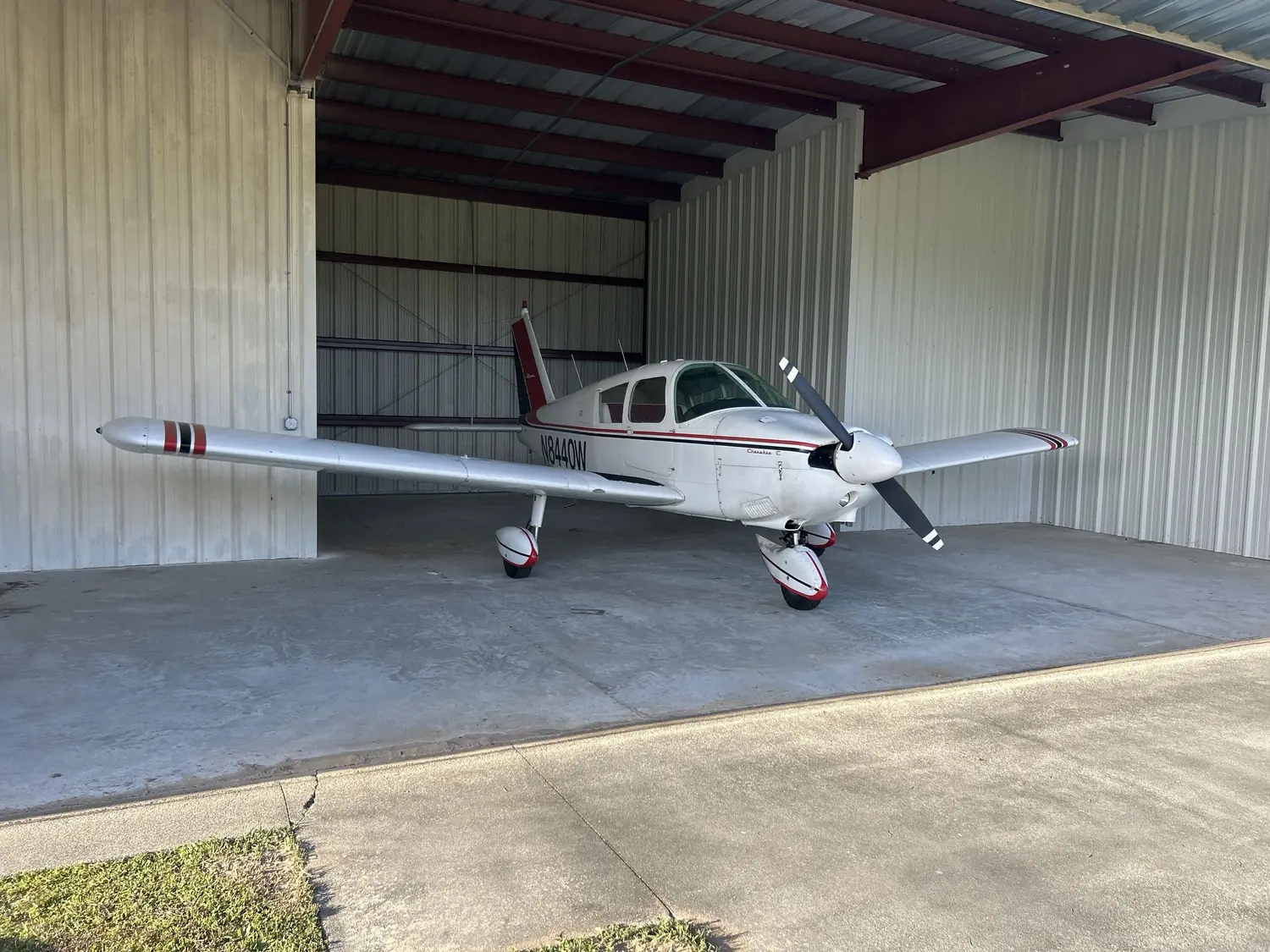Piper Cherokee C N8440W in its hangar at Roscoe Field